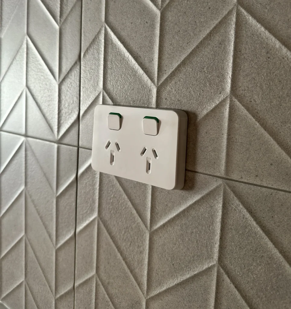 A photo of an electrical outlet which has been installed on a wall.