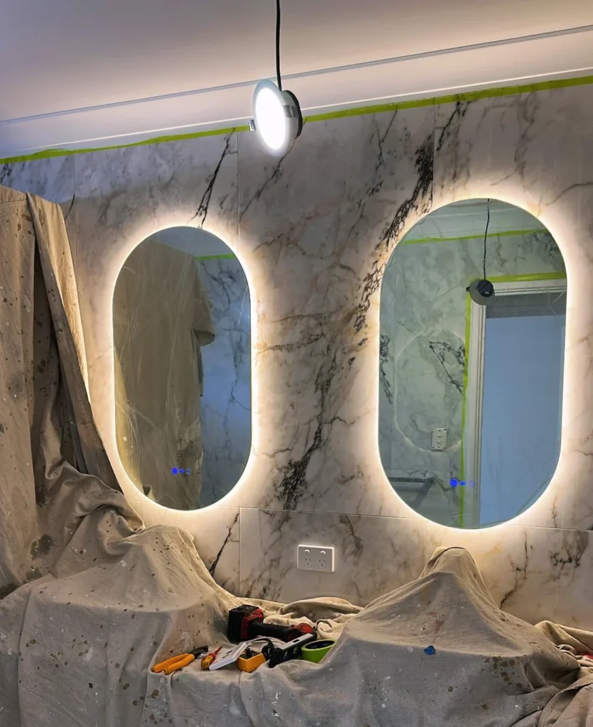 A photo of two mirrors with LED lighting installed behind them.
